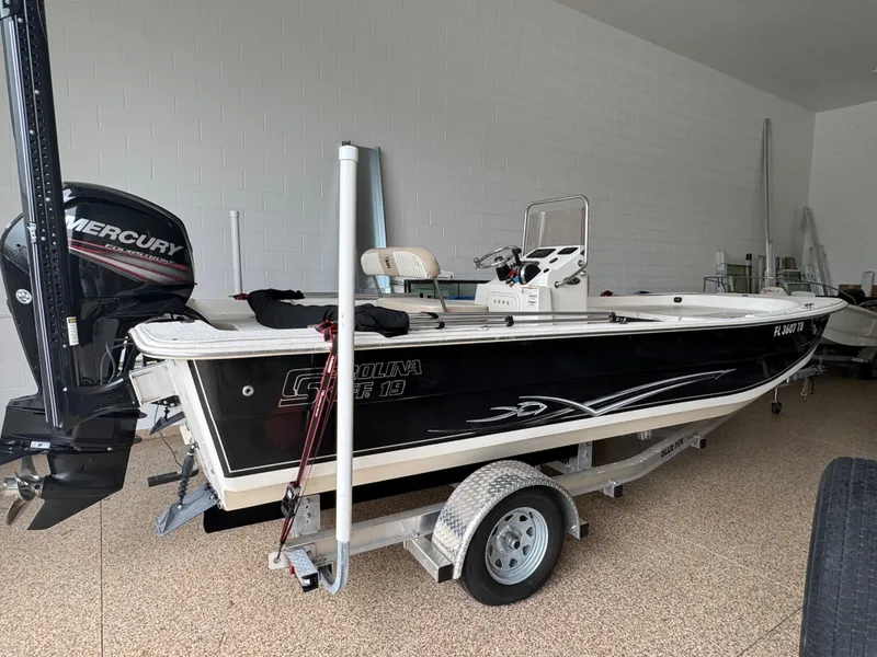 Slide: The Image of 2017 Carolina Skiff 19 LS boat on trailer with Mercury outboard motor. - 2