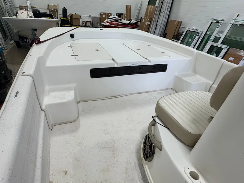 Slide: The Image of 2017 Carolina Skiff 19 LS boat interior with seating and storage compartments. - 6