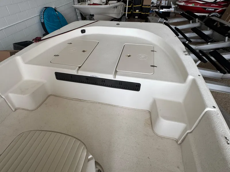 Slide: The Image of 2017 Carolina Skiff 19 LS boat interior with storage compartments and seating. - 7