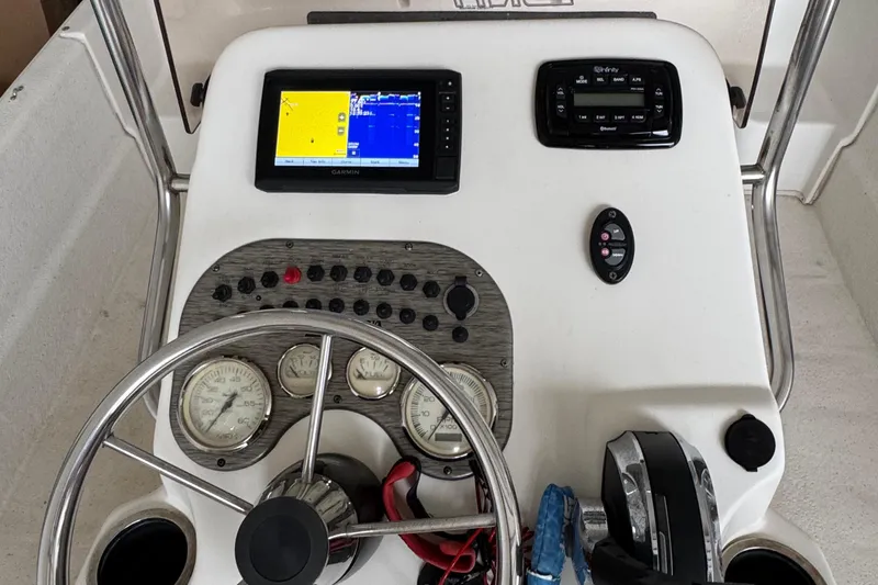 Slide: The Image of 2017 Carolina Skiff 19 LS boat dashboard with steering wheel and navigation instruments. - 9