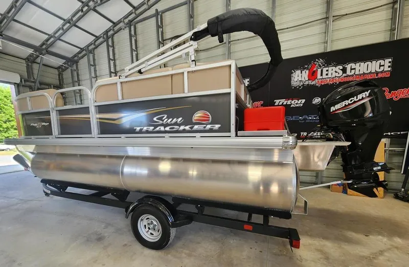 Slide: The Image of 2025 Sun Tracker PARTY BARGE® 16 DLX pontoon boat in a garage setting. - 7