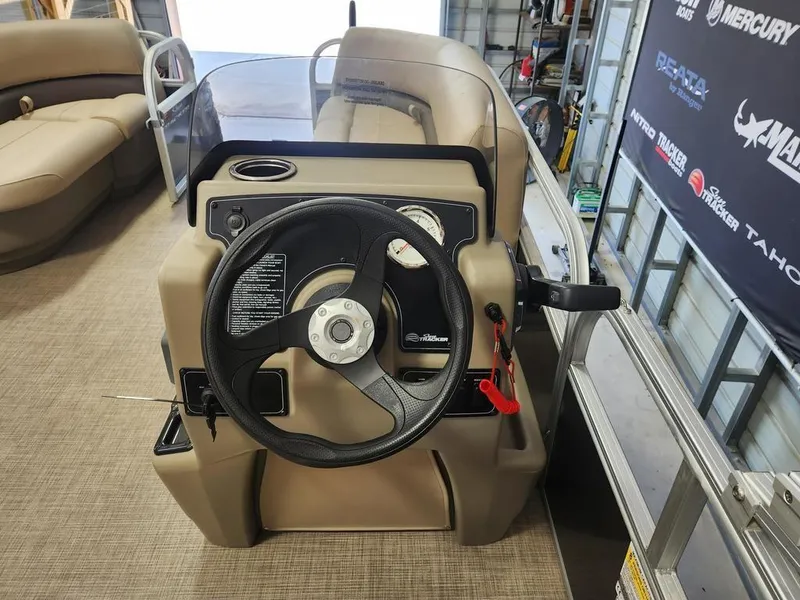 Slide: The Image of 2025 Sun Tracker PARTY BARGE® 16 DLX steering console with gauges and controls. - 8