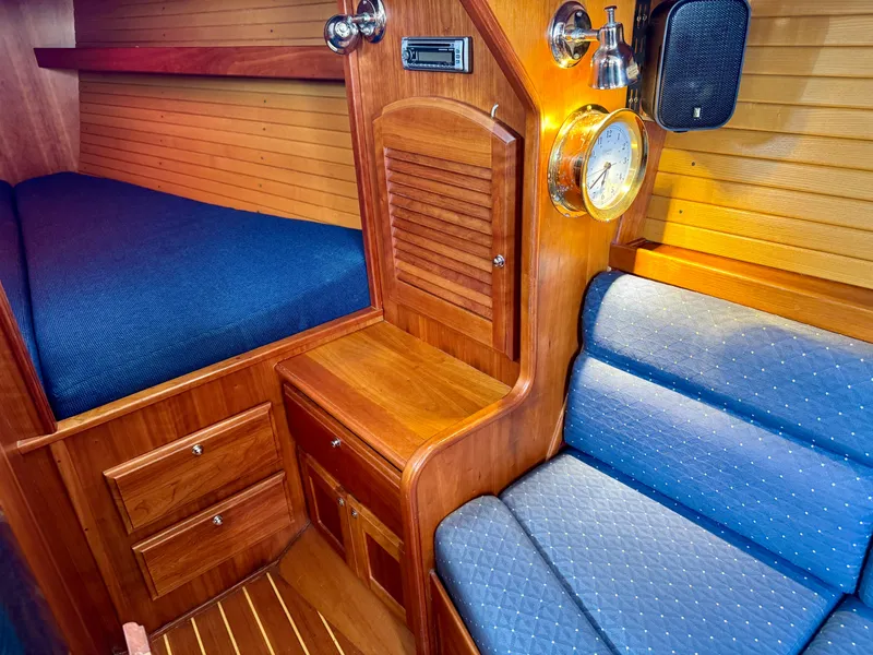 Slide: The Image of 2007 Sabre Spirit cabin interior with wooden finish and blue upholstery. - 11