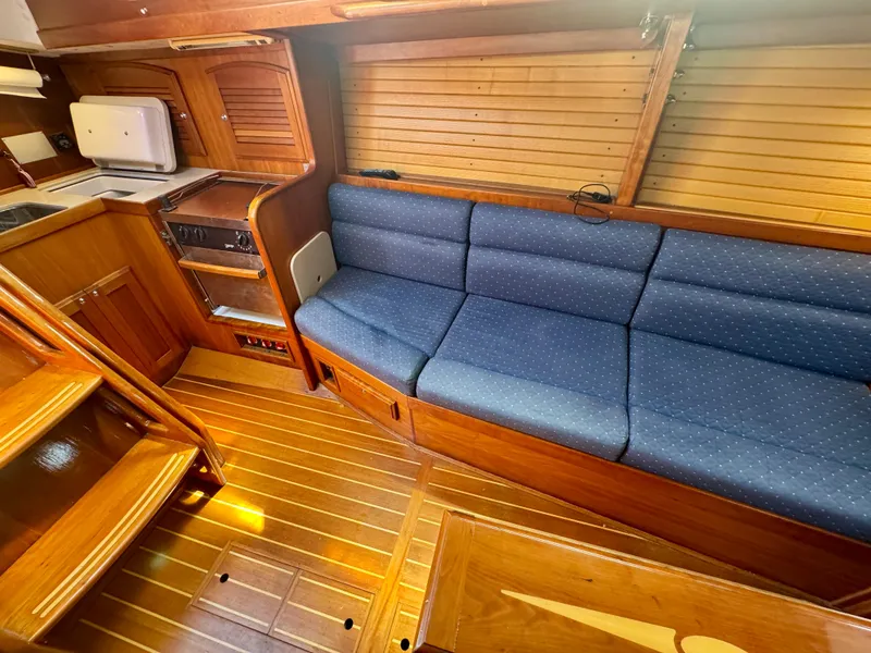 Slide: The Image of 2007 Sabre Spirit interior with blue cushioned seating and wooden cabinetry. - 12