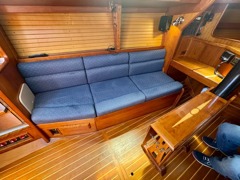 Slide: The Image of 2007 Sabre Spirit yacht interior with blue cushioned seating and wooden finishes. - 13