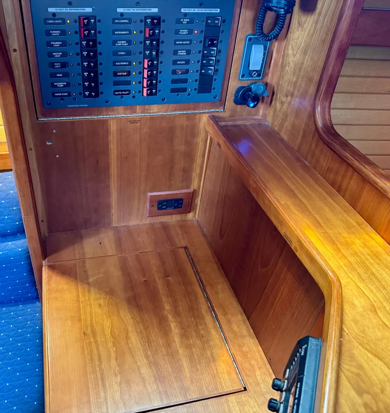 Slide: The Image of 2007 Sabre Spirit yacht interior with control panel and wooden finish. - 16