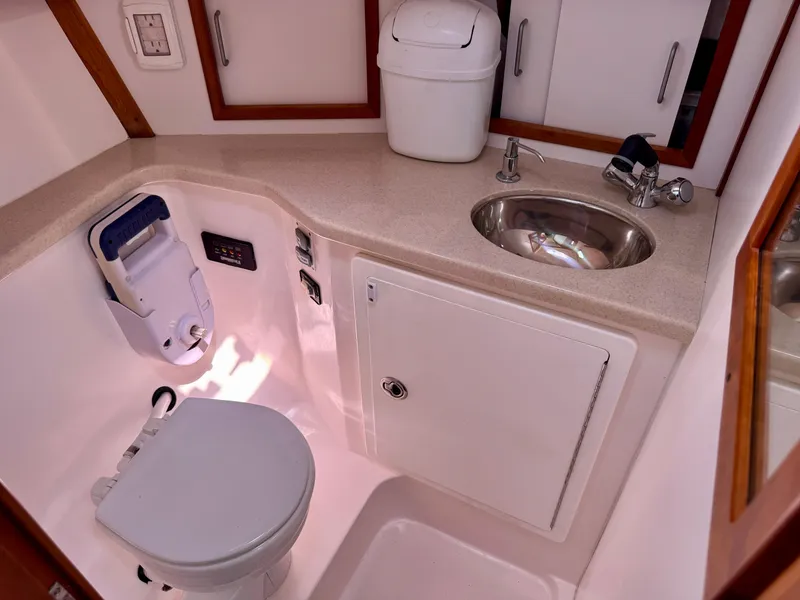 Slide: The Image of 2007 Sabre Spirit yacht bathroom with toilet, sink, and storage cabinets. - 20