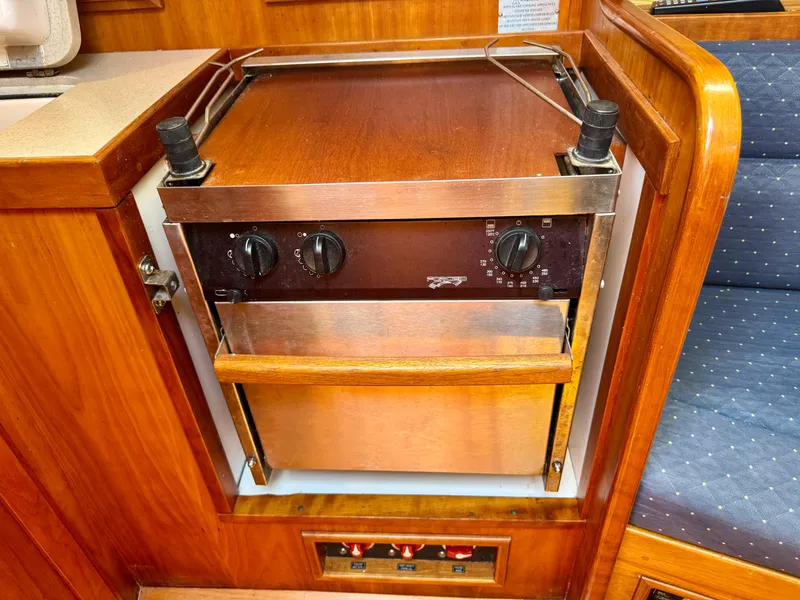 Slide: The Image of 2007 Sabre Spirit yacht interior with built-in wooden oven and control knobs. - 21