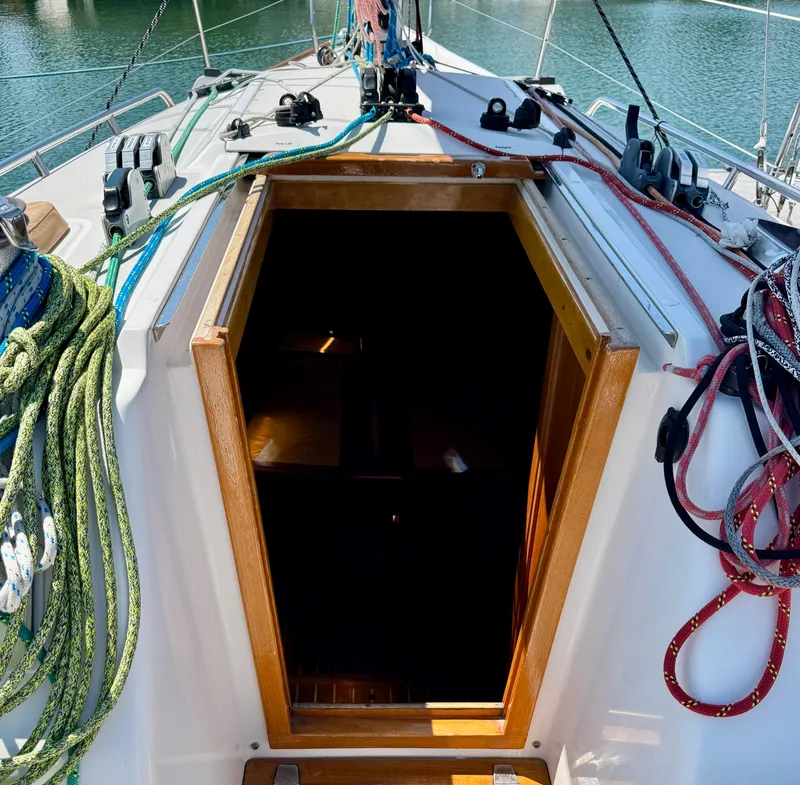 Slide: The Image of 2007 Sabre Spirit sailboat cockpit with open cabin entrance, colorful ropes, and nautical equipment. - 25