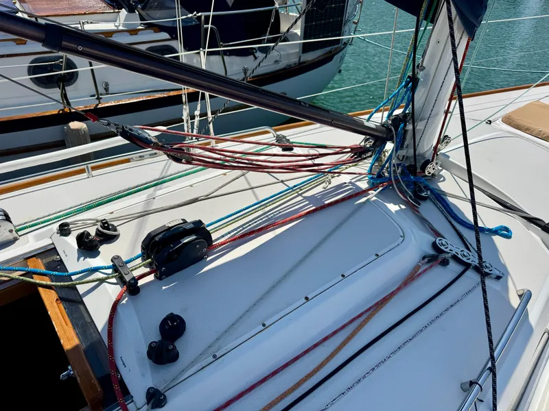 Slide: The Image of 2007 Sabre Spirit sailboat deck with rigging and ropes in a marina setting. - 28