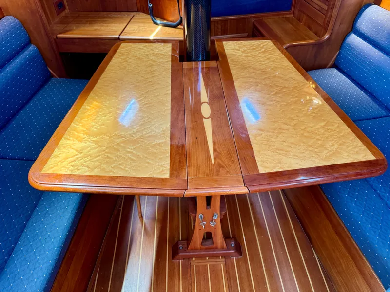Slide: The Image of Luxurious 2007 Sabre Spirit yacht interior with elegant wooden table and blue cushioned seating. - 7