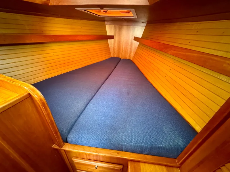 Slide: The Image of 2007 Sabre Spirit cabin interior with blue cushions and wooden paneling. - 8