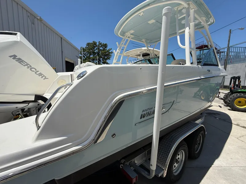 Slide: The Image of 2020 Boston Whaler 230 Vantage boat on trailer, side view, outdoors. - 12