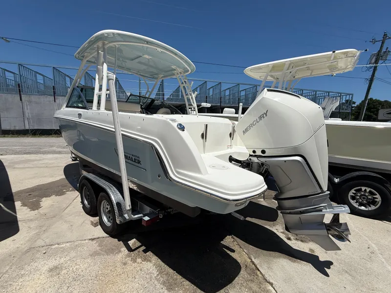 Slide: The Image of 2020 Boston Whaler 230 Vantage boat with Mercury engine on trailer, sunny day. - 14