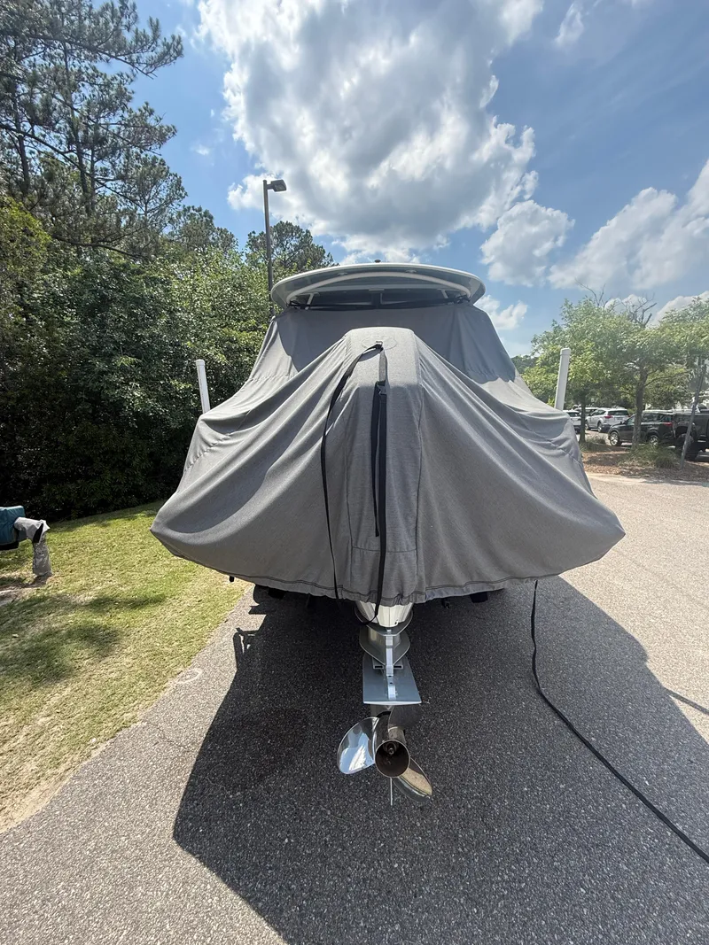 Slide: The Image of 2020 Boston Whaler 230 Vantage boat covered, parked on a sunny day. - 20