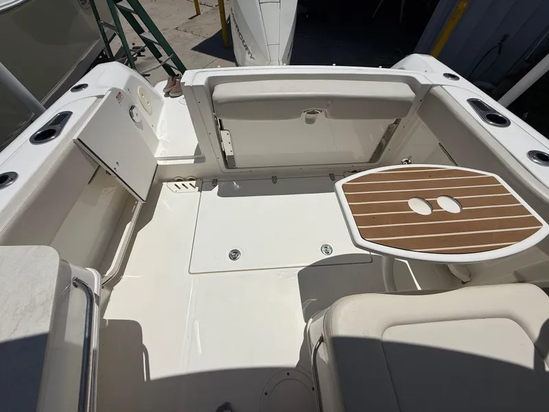 Slide: The Image of 2020 Boston Whaler 230 Vantage boat interior with seating and wooden table. - 23