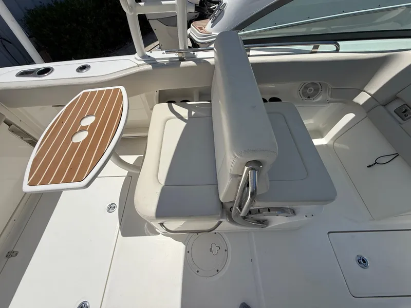 Slide: The Image of 2020 Boston Whaler 230 Vantage interior with seating and wooden table. - 25