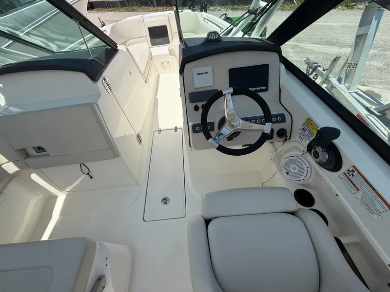 Slide: The Image of 2020 Boston Whaler 230 Vantage boat interior with steering wheel and seating area. - 29