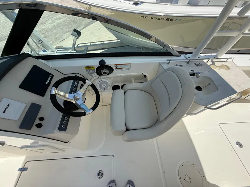Slide: The Image of 2020 Boston Whaler 230 Vantage boat interior with steering wheel and seating area. - 31