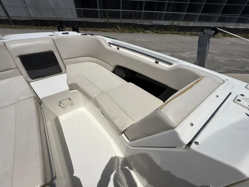 Slide: The Image of 2020 Boston Whaler 230 Vantage boat interior with white seating and storage compartments. - 33
