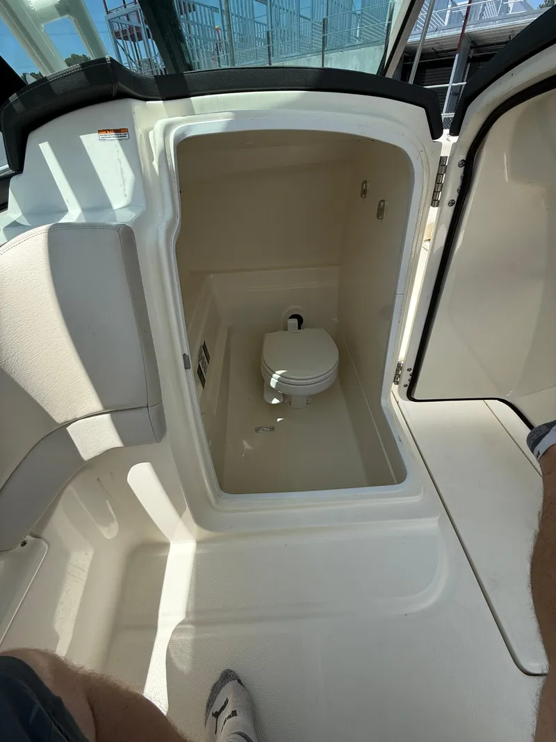 Slide: The Image of 2020 Boston Whaler 230 Vantage boat interior with compact marine toilet. - 34