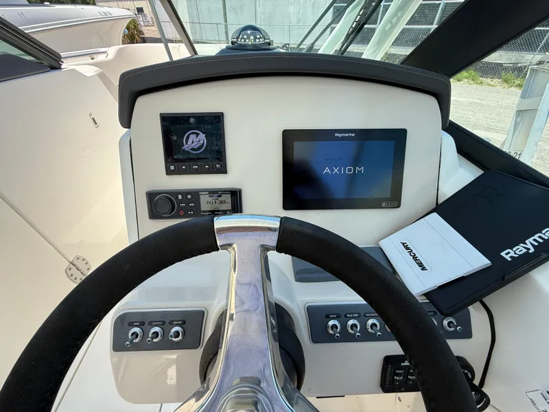 Slide: The Image of 2020 Boston Whaler 230 Vantage helm with Raymarine Axiom display and control panel. - 35