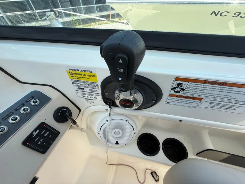 Slide: The Image of Control panel of a 2020 Boston Whaler 230 Vantage boat, featuring throttle and warning labels. - 40