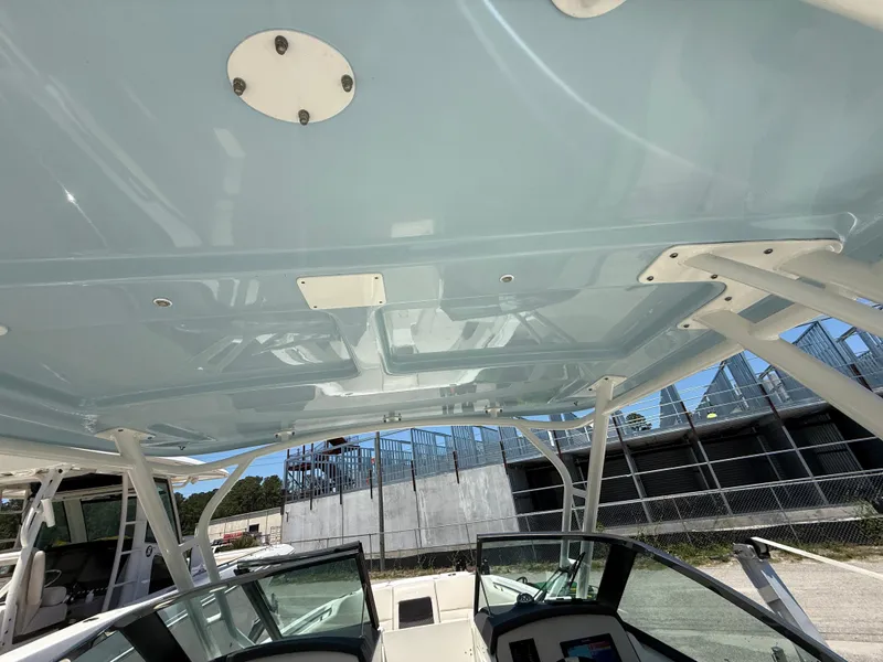 Slide: The Image of Boston Whaler 230 Vantage 2020 boat interior with glass windshield and sturdy roof structure. - 45