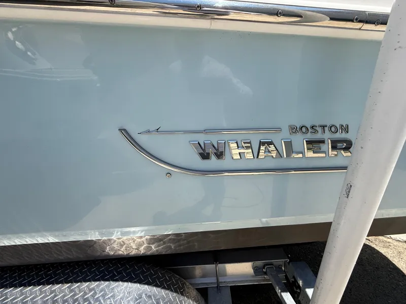 Slide: The Image of 2020 Boston Whaler 230 Vantage boat logo on side panel. - 8