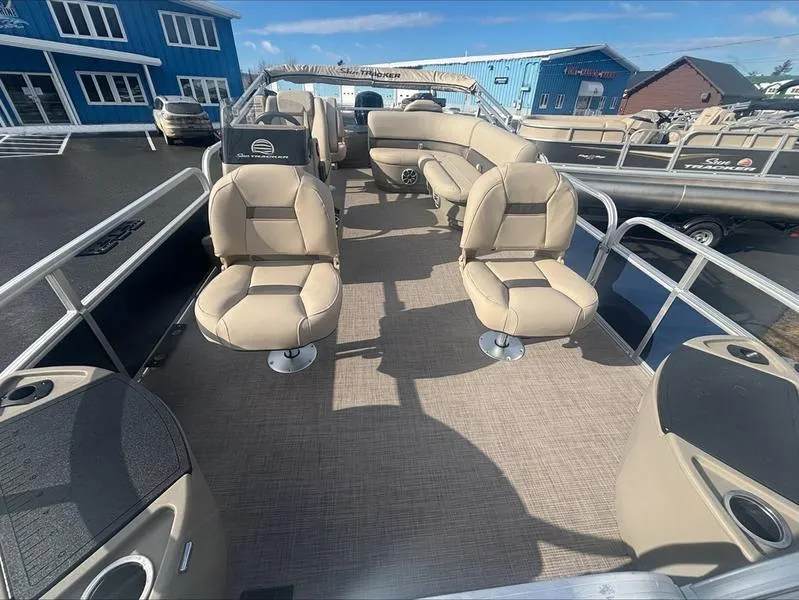 Slide: The Image of 2025 Sun Tracker BB 18 DLX pontoon boat with beige seating and spacious deck layout. - 11