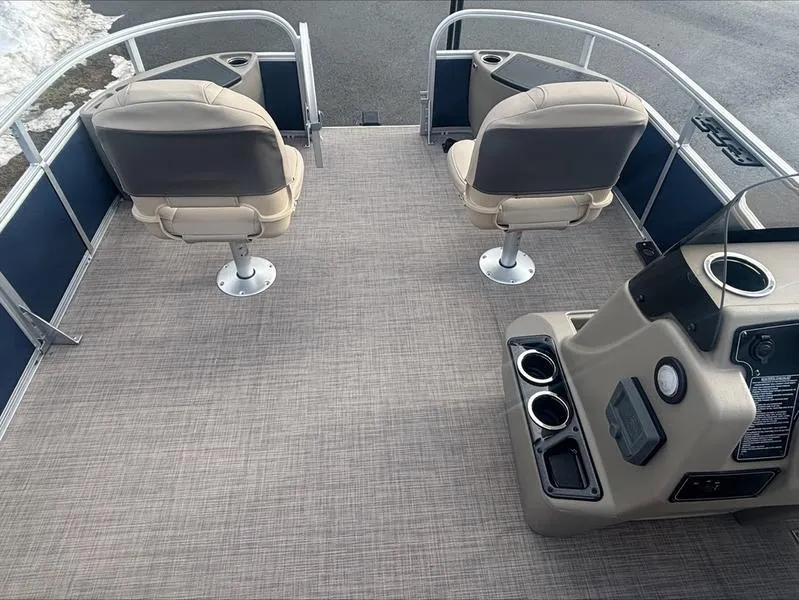 Slide: The Image of 2025 Sun Tracker BB 18 DLX pontoon boat interior with two seats and control panel. - 12