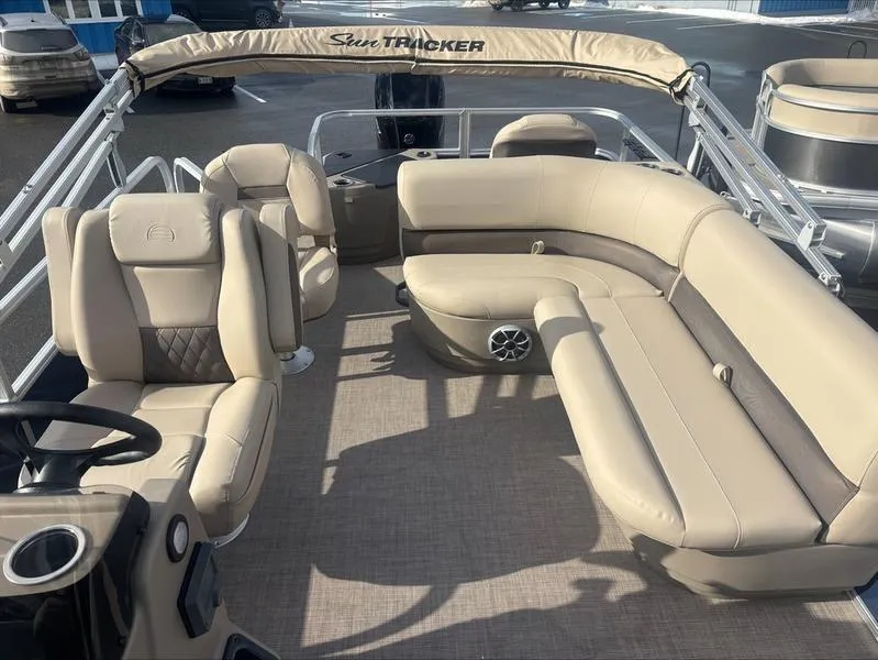 Slide: The Image of 2025 Sun Tracker BB 18 DLX pontoon boat with beige seating and spacious interior. - 8