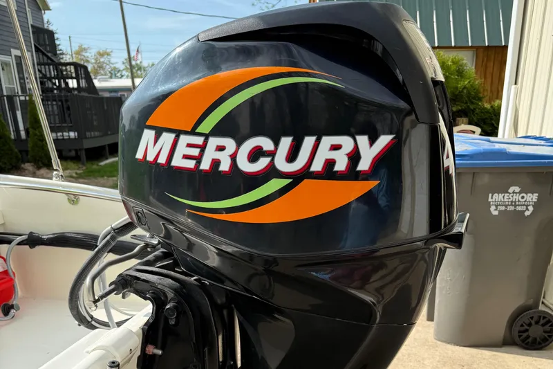 Slide: The Image of Mercury outboard motor on a 2009 Boston Whaler 130 Super Sport boat. - 14