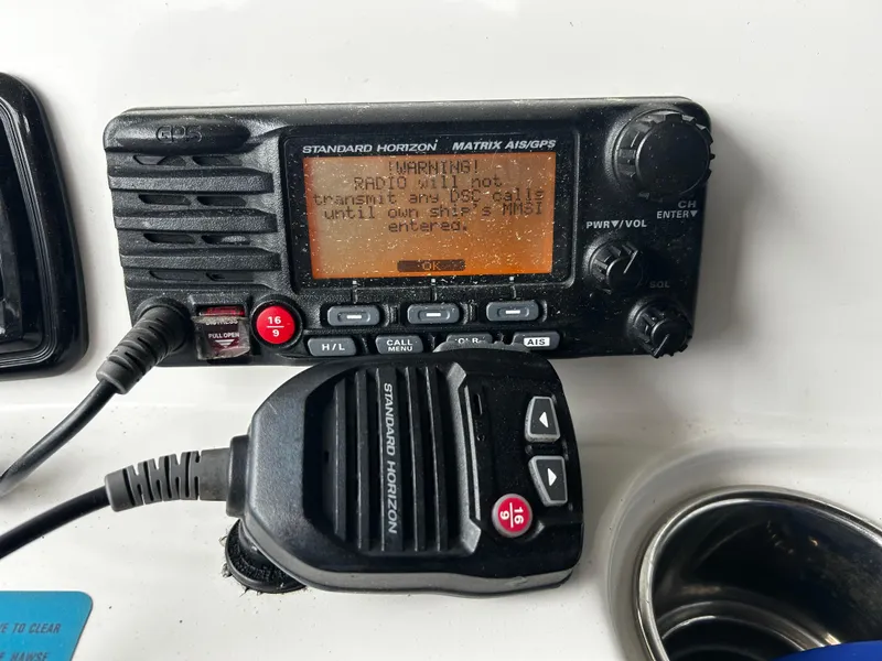 Slide: The Image of Standard Horizon marine radio on 2018 NauticStar 25 XS Offshore boat dashboard. - 14