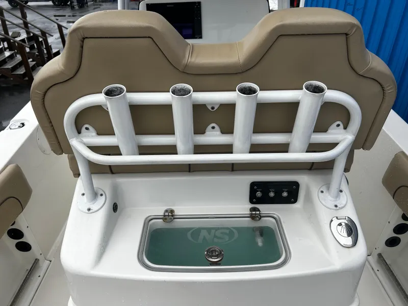 Slide: The Image of 2018 NauticStar 25 XS Offshore boat with rod holders and livewell. - 18