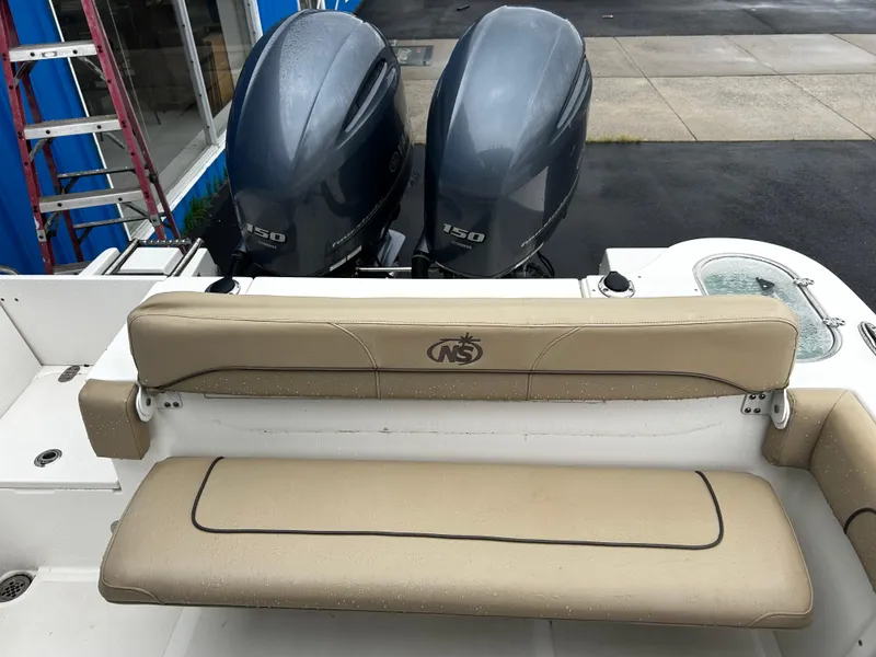 Slide: The Image of 2018 NauticStar 25 XS Offshore boat with twin 150 engines and beige seating. - 19