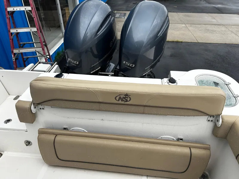 Slide: The Image of 2018 NauticStar 25 XS Offshore boat with dual outboard engines and tan seating. - 20