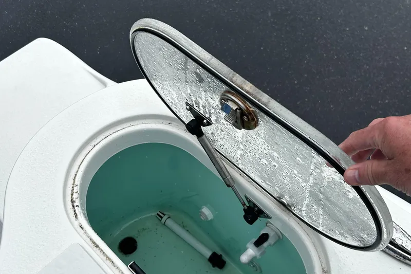 Slide: The Image of Open hatch of 2018 NauticStar 25 XS Offshore boat, showing interior compartment. - 21