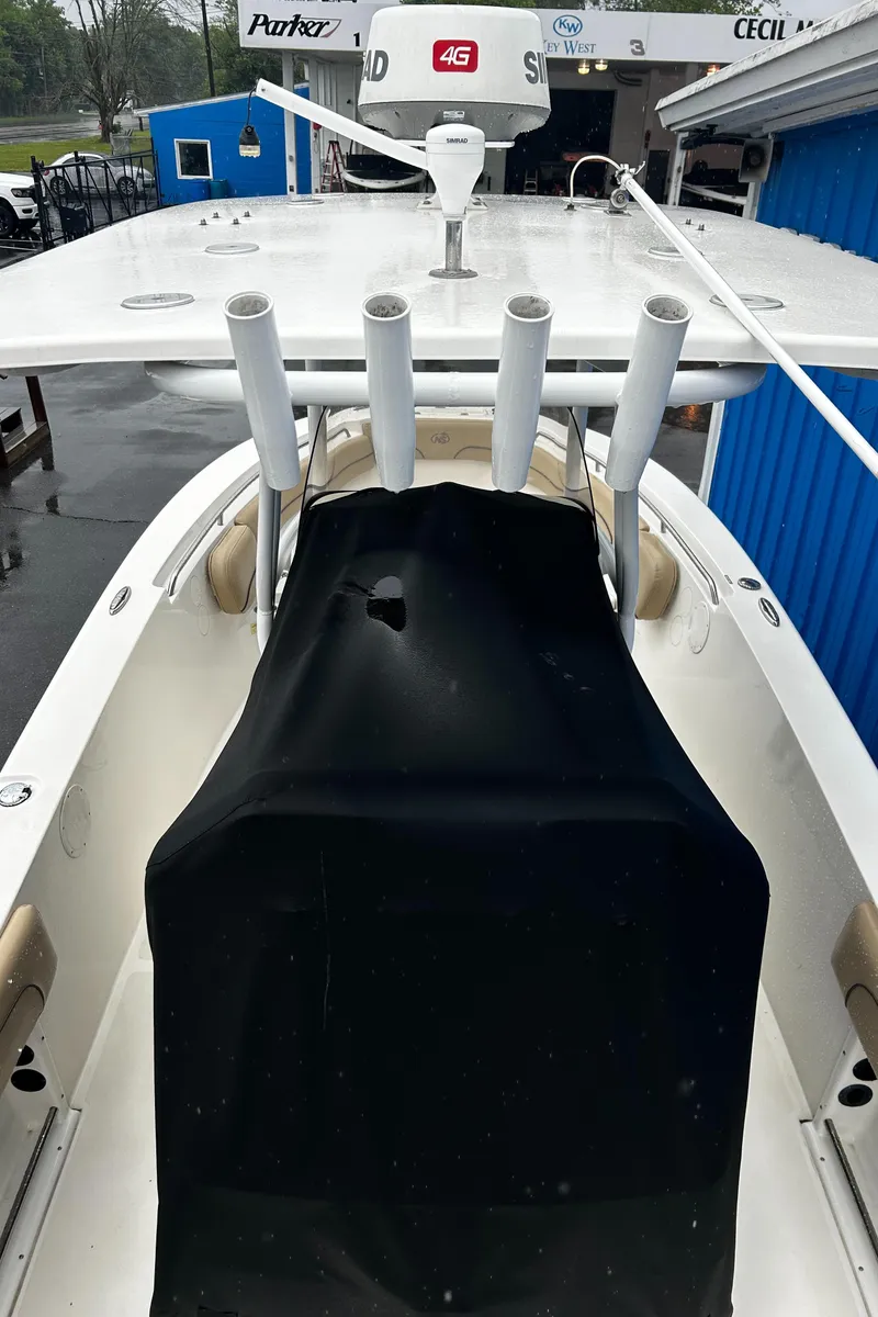 Slide: The Image of 2018 NauticStar 25 XS Offshore boat with covered console and rod holders. - 24