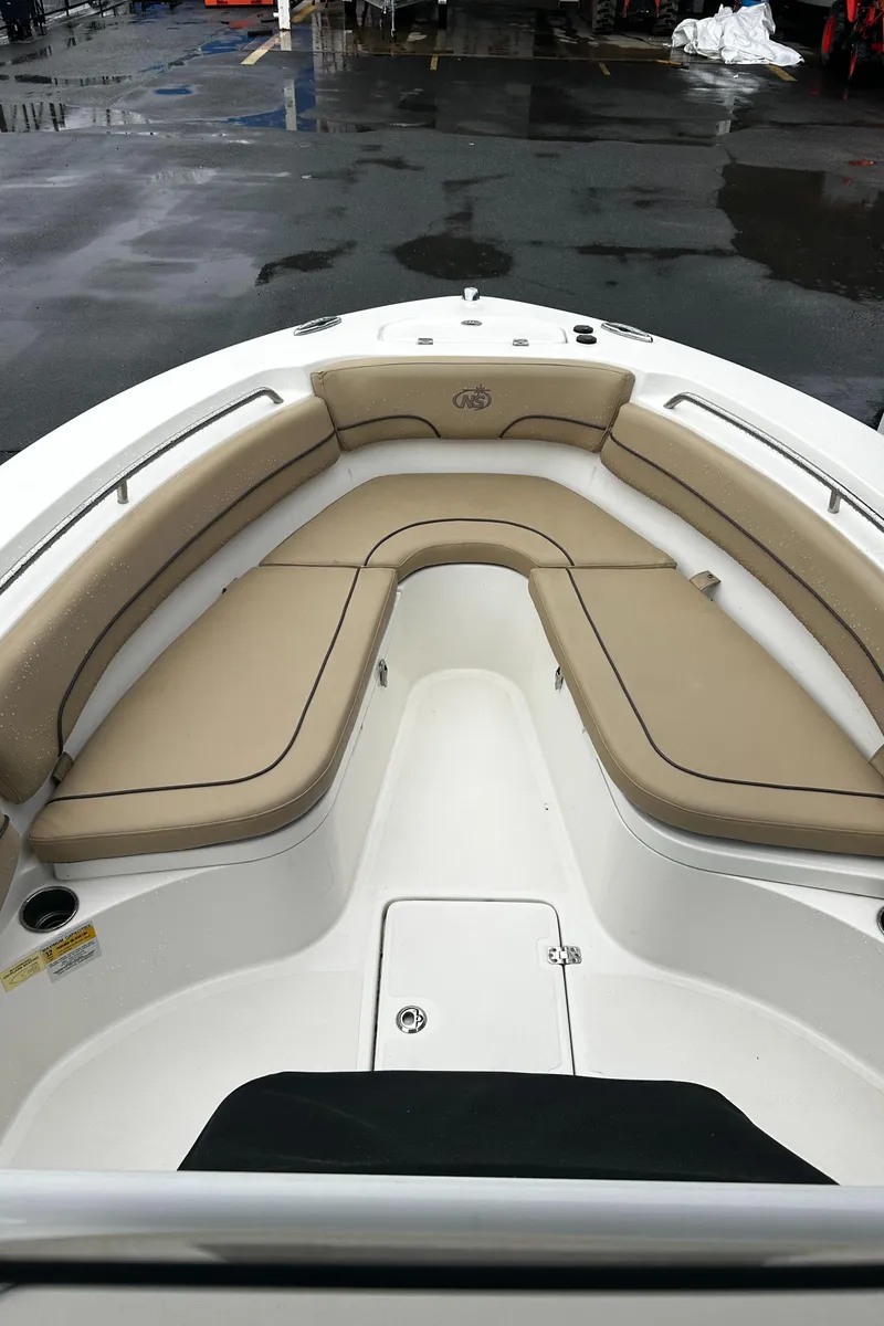 Slide: The Image of 2018 NauticStar 25 XS Offshore boat with tan seating and spacious deck. - 28