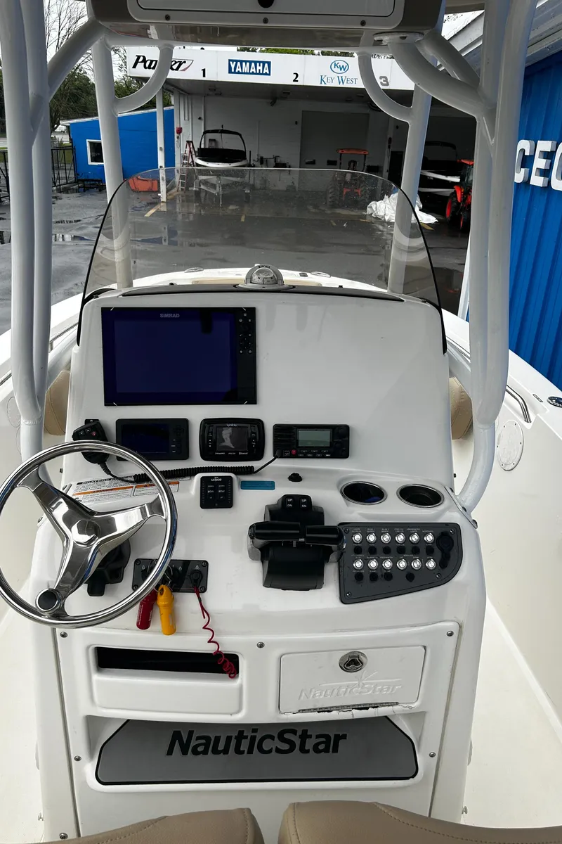 Slide: The Image of 2018 NauticStar 25 XS Offshore boat console with steering wheel and navigation equipment. - 30