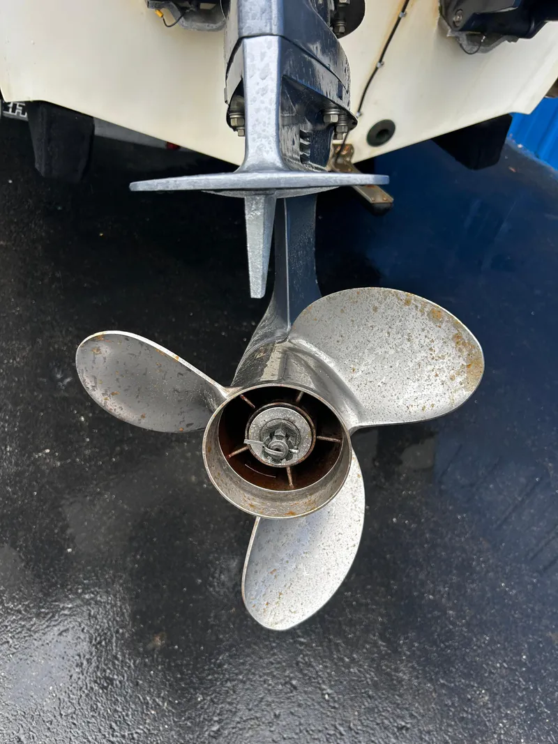 Slide: The Image of 2018 NauticStar 25 XS Offshore boat propeller on wet pavement. - 36