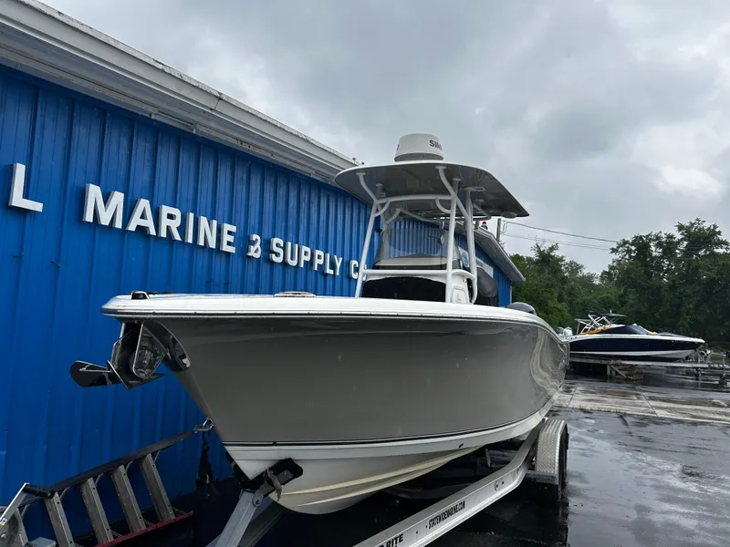 Slide: The Image of 2018 NauticStar 25 XS Offshore boat on trailer near marine supply store. - 7