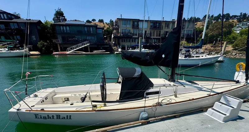 Slide: The Image of 2005 J Boats J/100 sailboat docked in a marina with waterfront homes. - 12