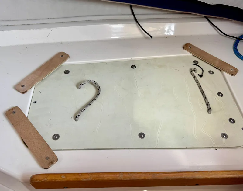 Slide: The Image of Deck detail of a 2005 J Boats J/100 sailboat, featuring a secured hatch cover. - 19