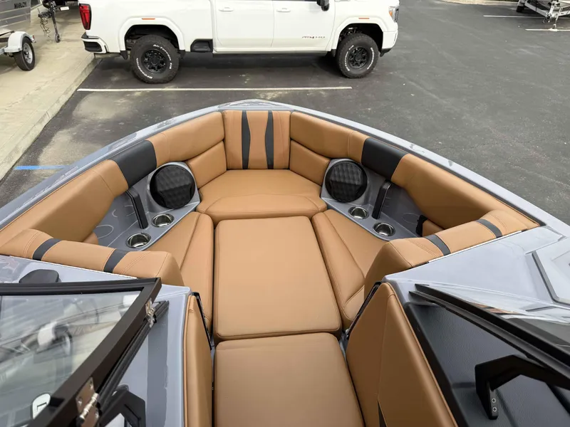 Slide: The Image of 2025 Malibu Wakesetter 22 LSV boat interior with tan leather seating and cup holders. - 10
