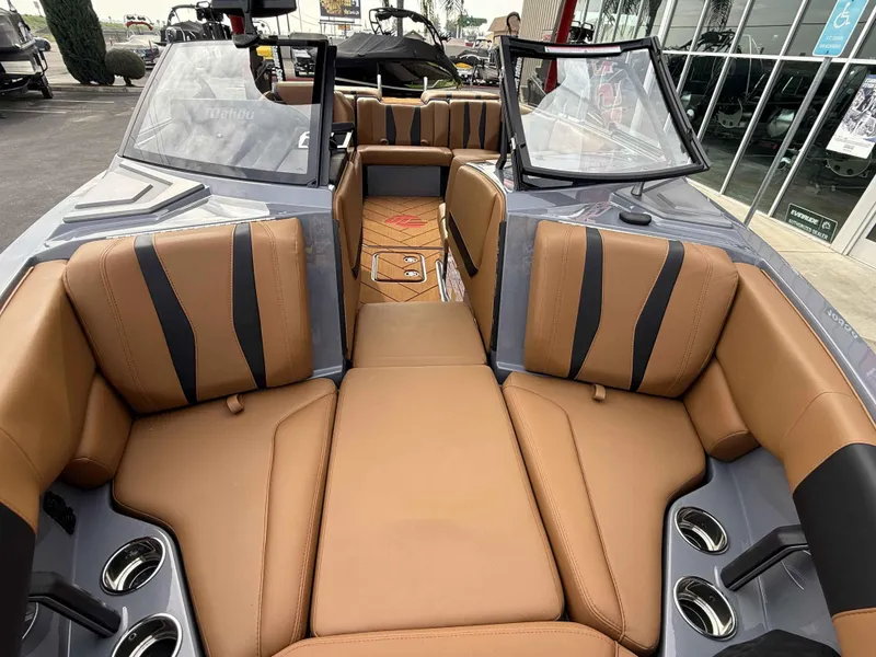 Slide: The Image of 2025 Malibu Wakesetter 22 LSV interior with tan leather seats and cup holders. - 11
