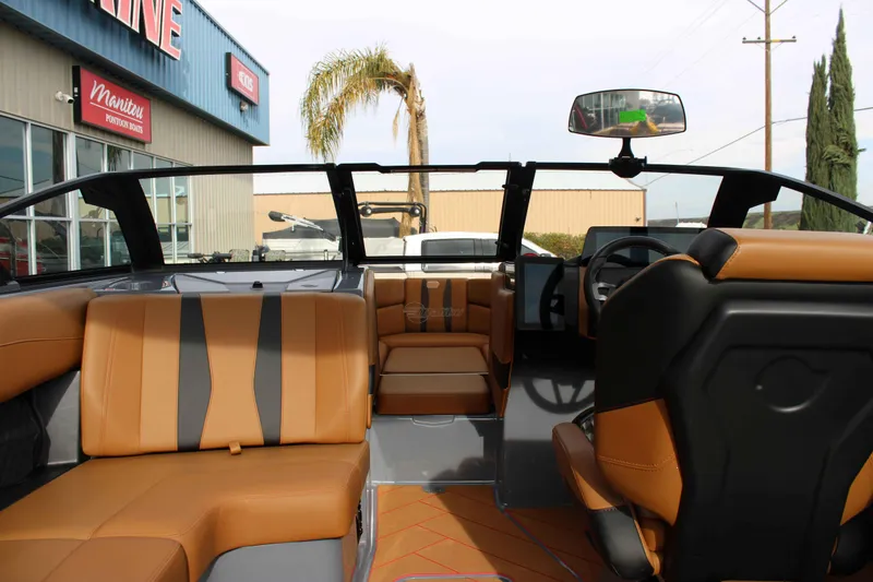Slide: The Image of Interior of 2025 Malibu Wakesetter 22 LSV boat with tan seating and modern dashboard. - 12
