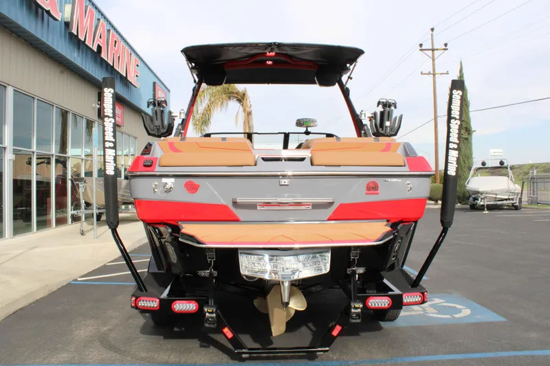 Slide: The Image of 2025 Malibu Wakesetter 22 LSV boat at a marine dealership, rear view. - 6