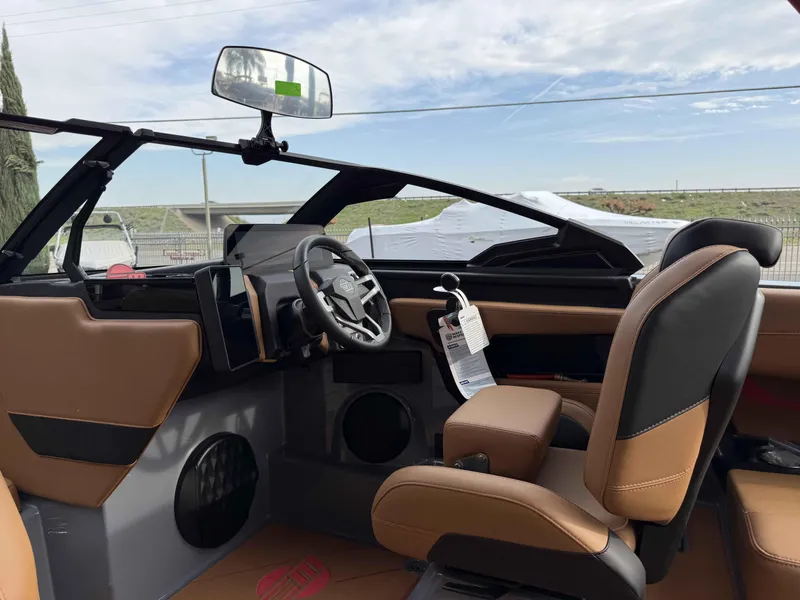 Slide: The Image of 2025 Malibu Wakesetter 22 LSV interior with modern dashboard and tan leather seating. - 9